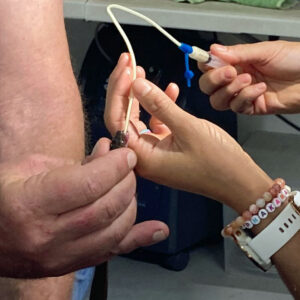 brown house snake being held and fed by tube
